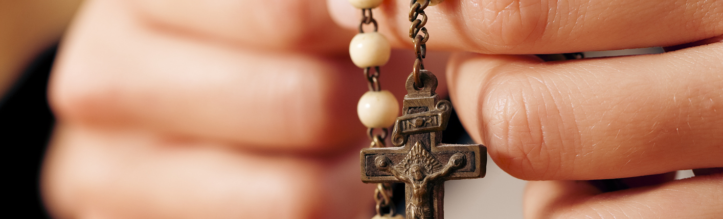 Woman praying with rosary to God rosary